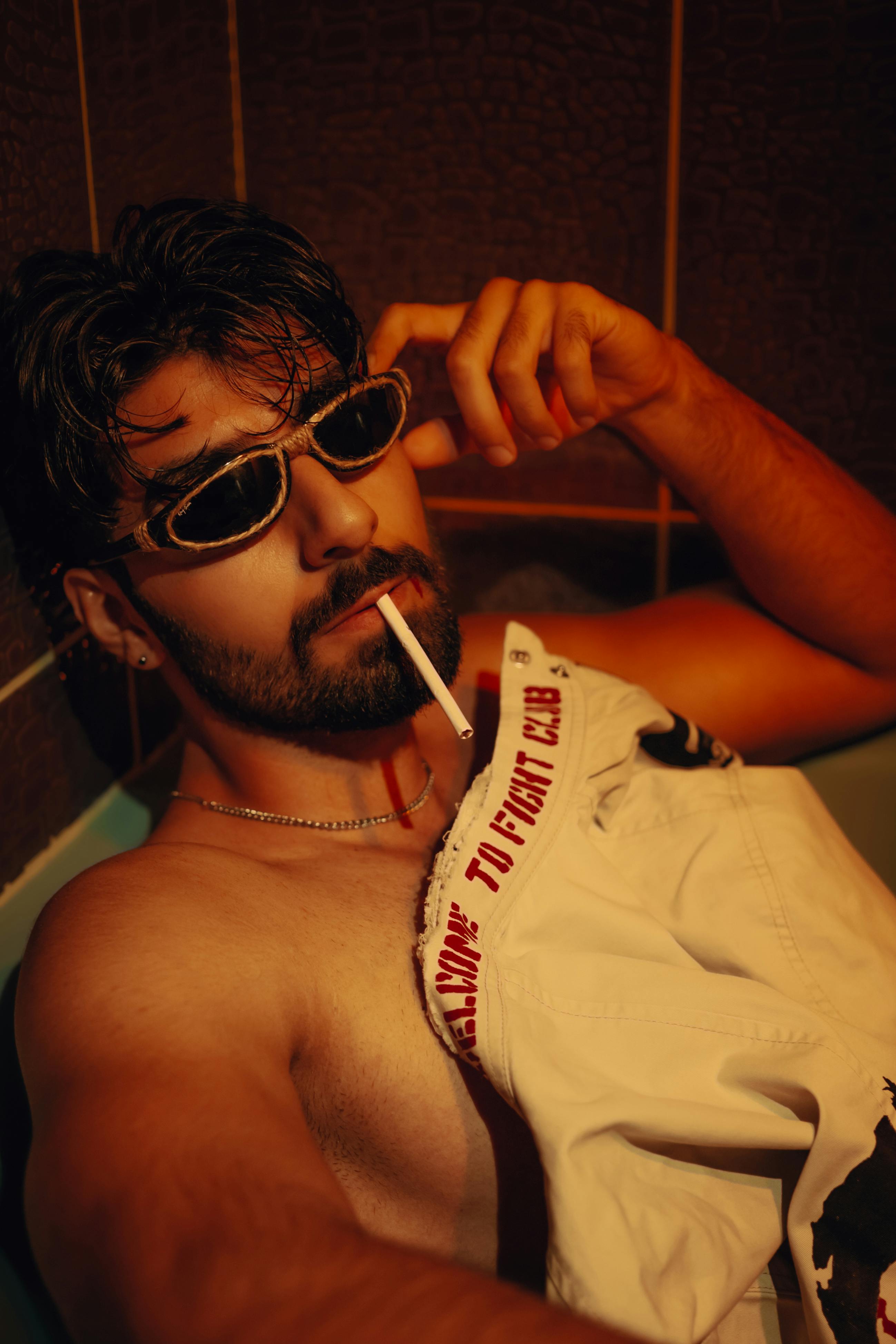 free photo of man in sunglasses smoking cigarette