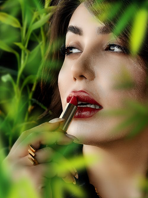 Woman Applying Red Lipstick