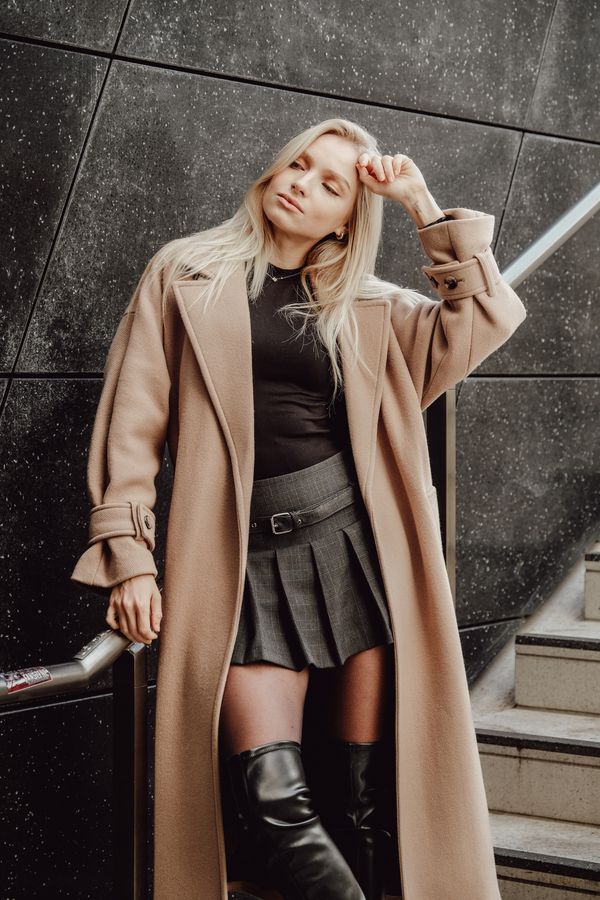 Woman in pleated skirt and fitted sweater