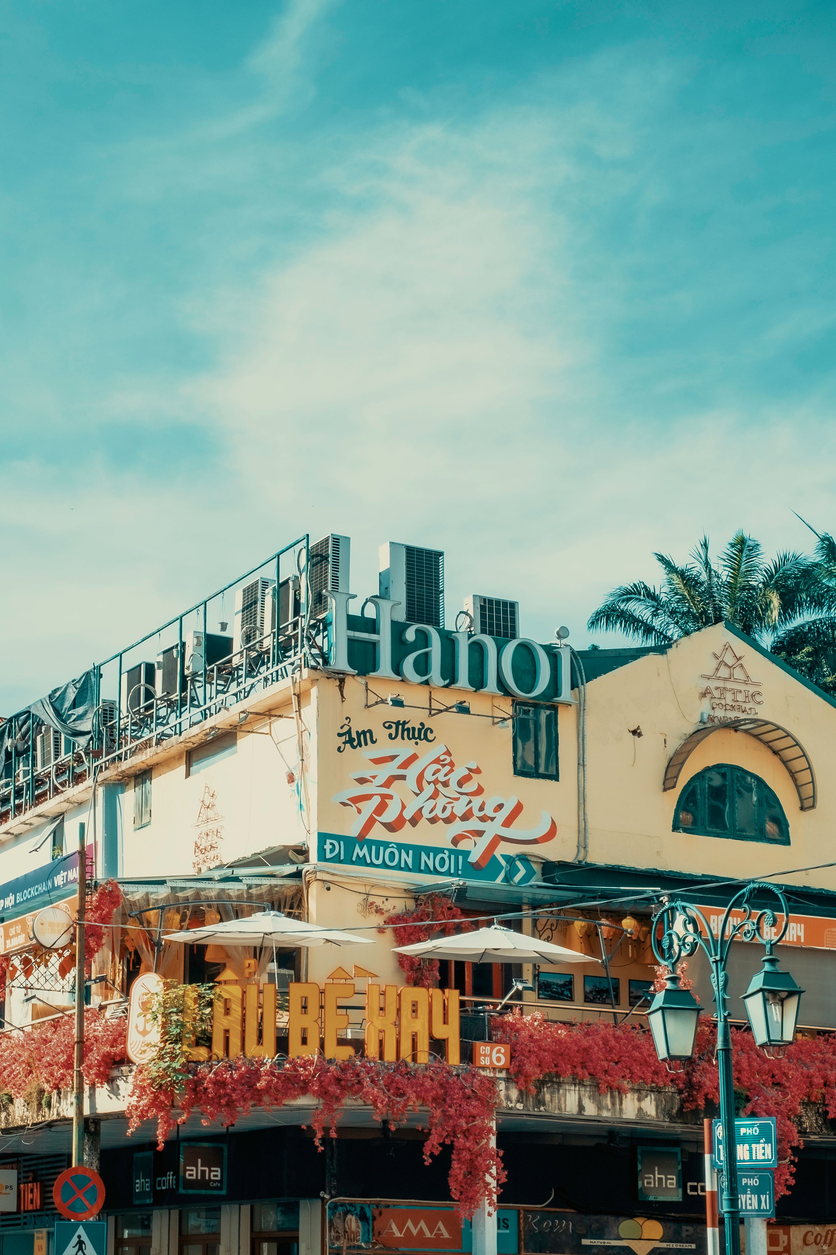 Colorful urban scene of a restaurant in Hanoi, Vietnam under a bright sky.