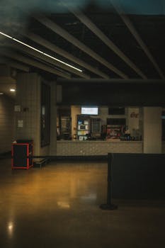 An empty and dimly lit concession stand interior at an airport, reflecting urban design.