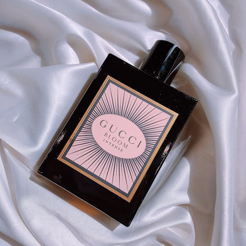 Bottle of Gucci Bloom Eau de Parfum Intense on a White Silk
