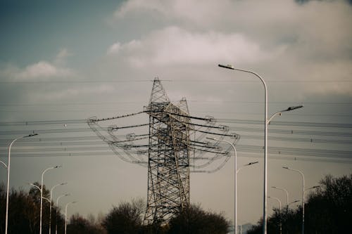 Transmission Tower with High-Voltage Power Lines Over the Highway 