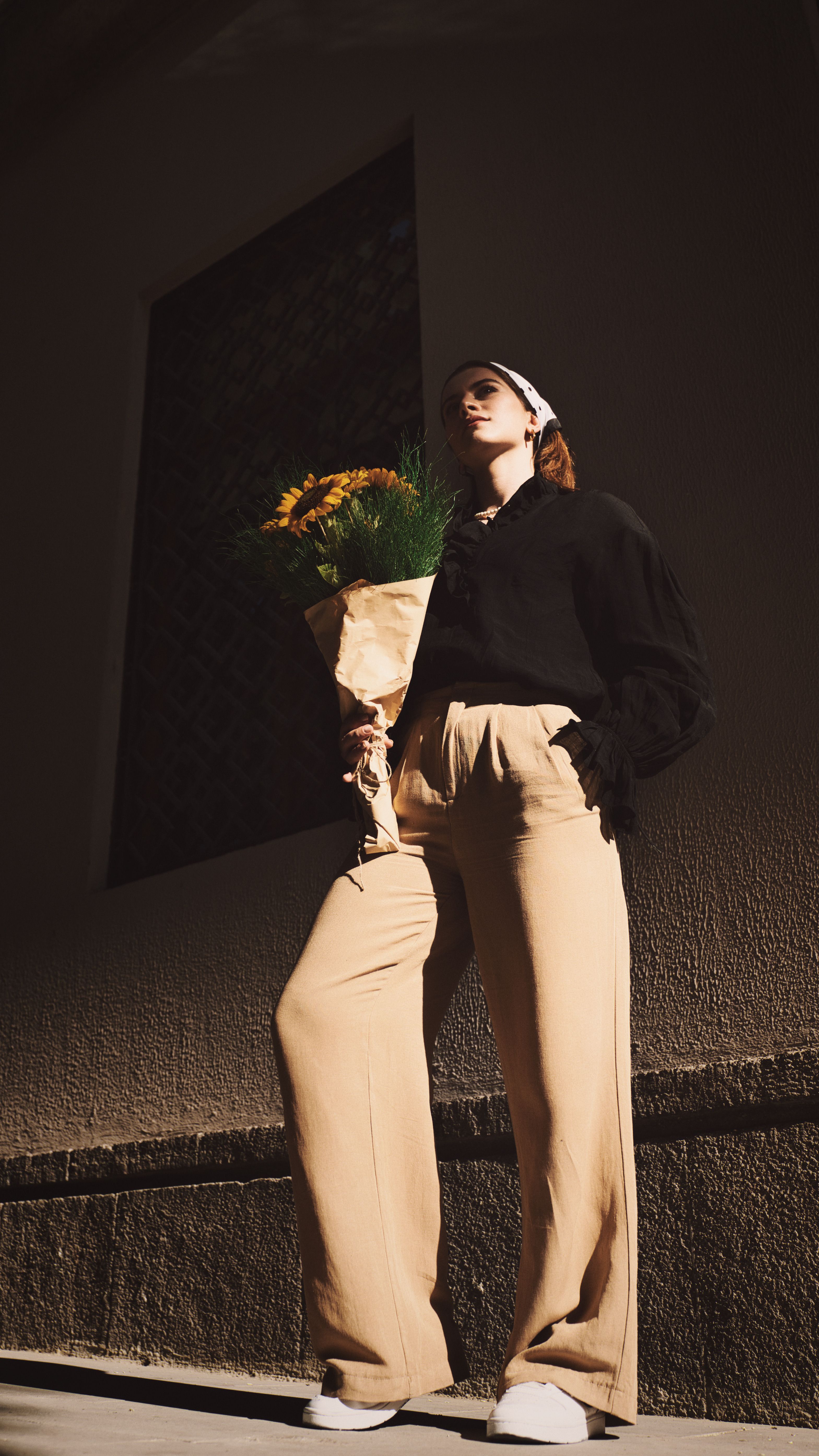 Woman Standing with Sunflowers · Free Stock Photo
