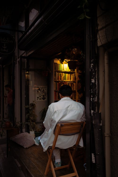 Man in White Shirt Sitting on Chair