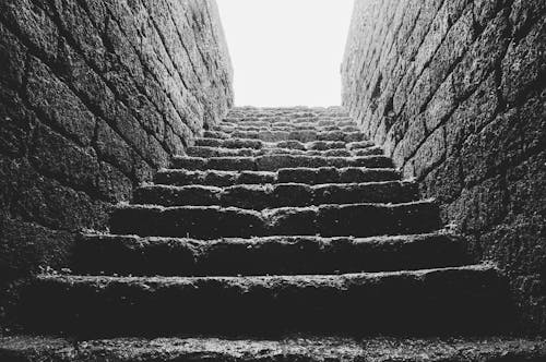 Low Angle Grayscale Photo of Empty Brick Stairs