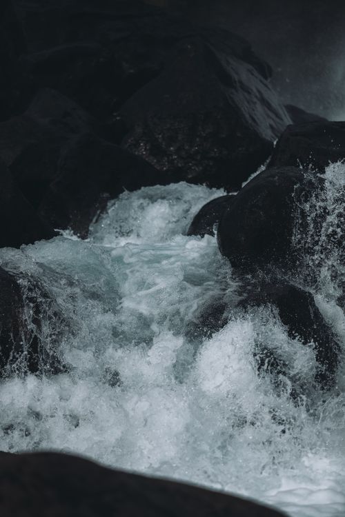 Free A dramatic waterfall scene in Iceland featuring dark rocks and foaming cascades. Stock Photo