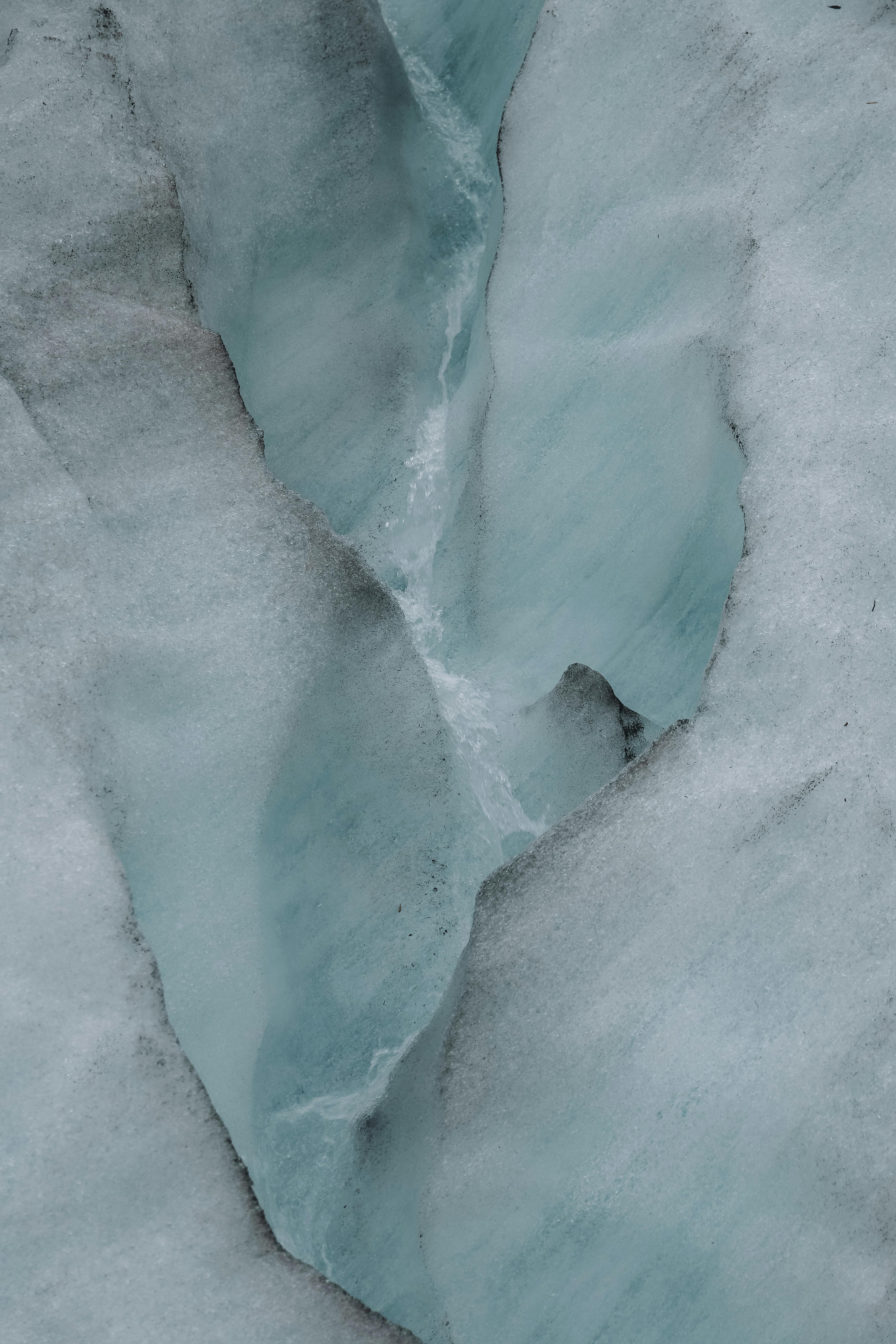 A stunning close-up of a glacier crevasse in Iceland, capturing the icy textures and shades of blue.