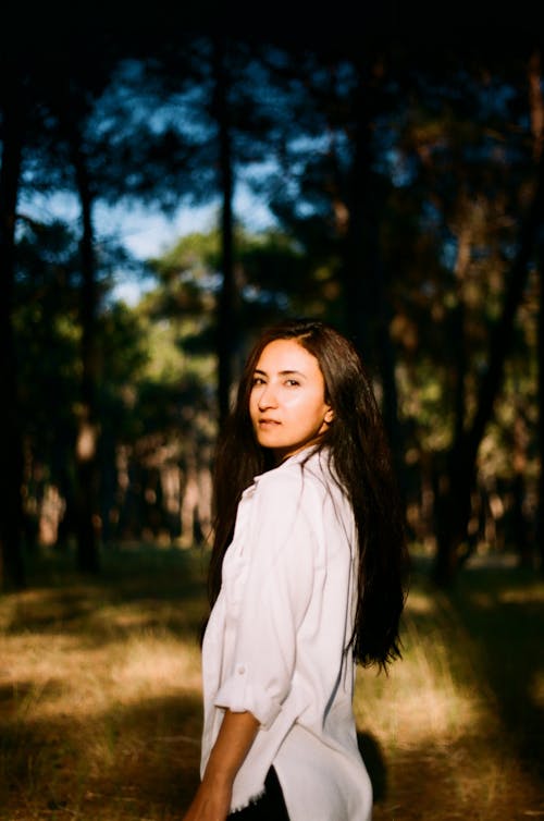 Brunette Woman in White Shirt in Forest