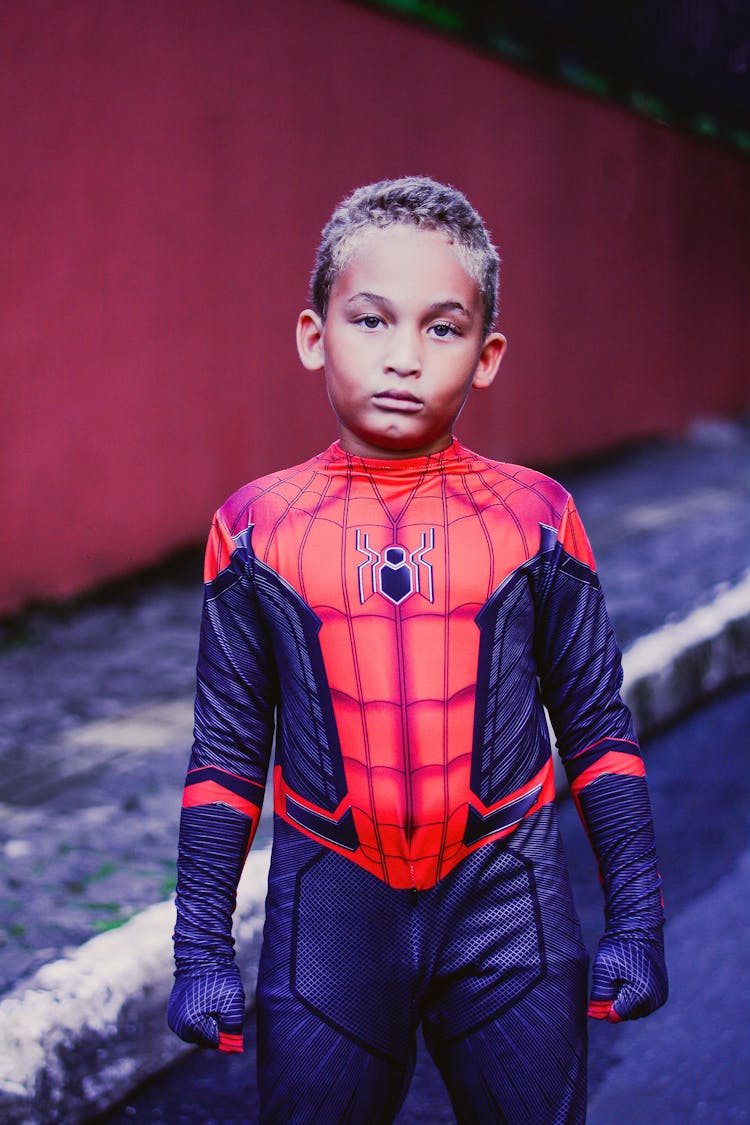 A Little Boy In Spiderman Costume 