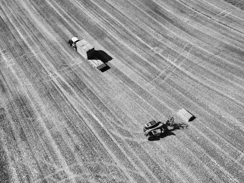 Aerial Photography of a Tractor and Farming Machinery in the Field 