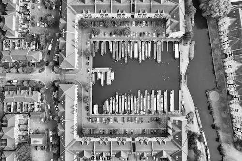 Buildings around Harbor with Moored Ships in Black and White