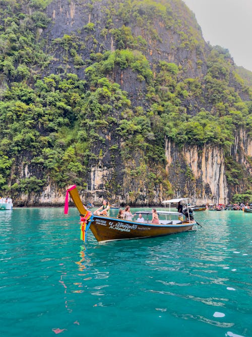 People on Boat near Rock Formation in Thailand