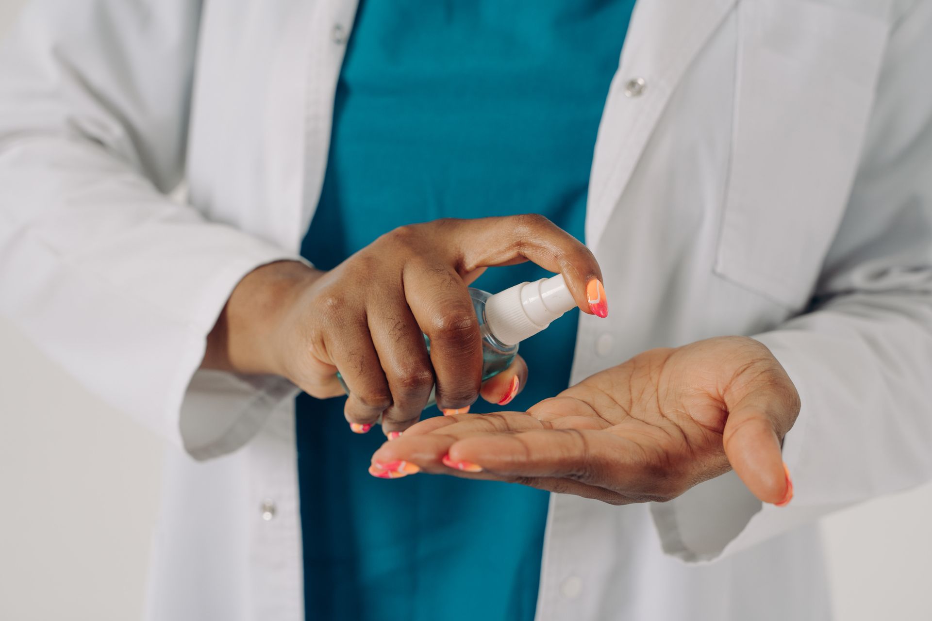 Doctor Using Hand Sanitizer on her Hands