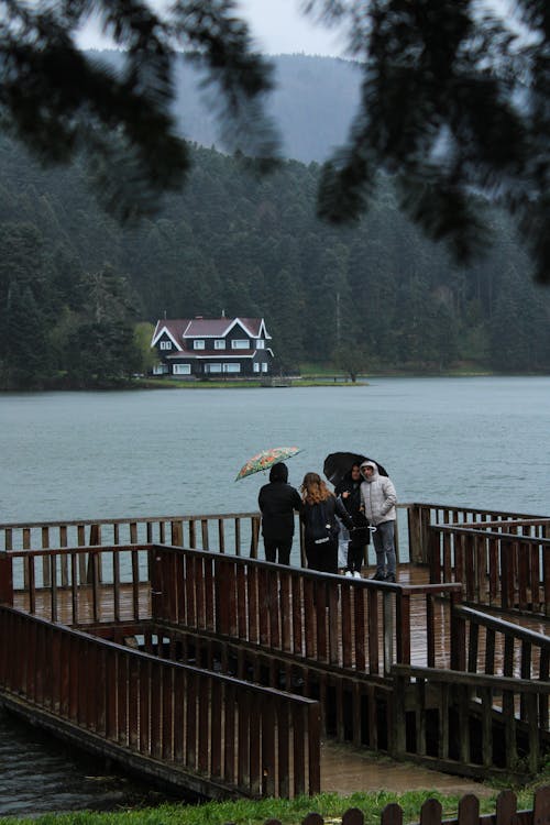 People on Wooden Pier on Lake