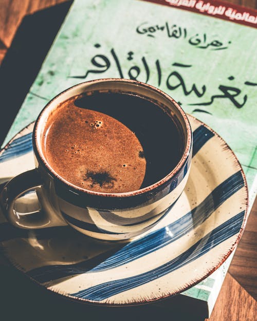 Free Close-up of a Cup of Black Coffee Standing on a Book  Stock Photo