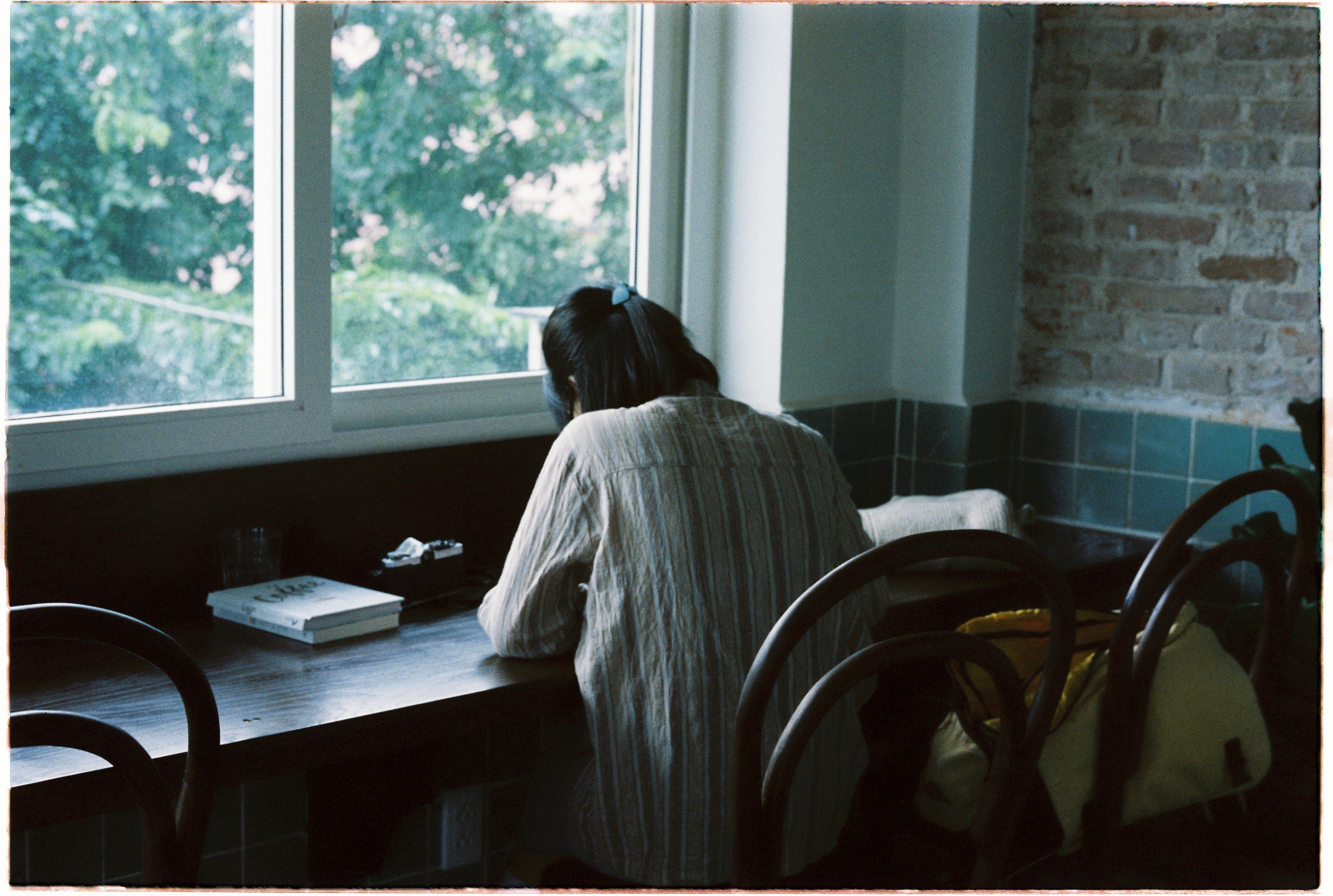 Woman Sitting by the Window in the Dark · Free Stock Photo