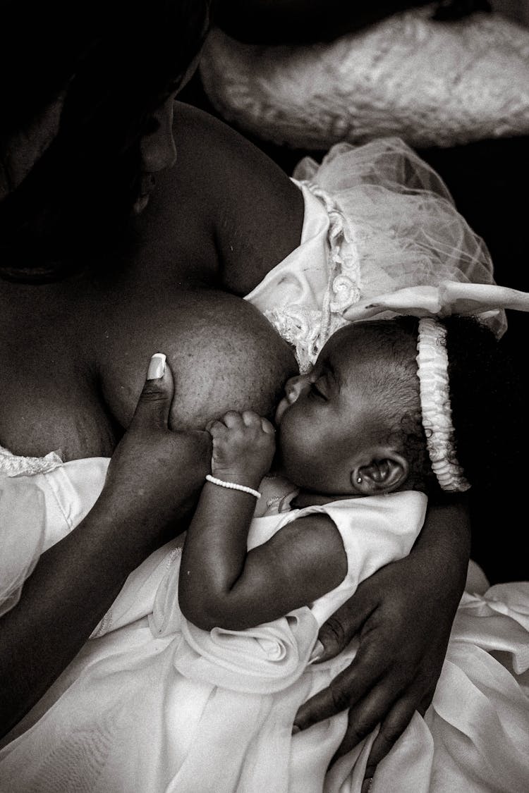 Woman Breastfeeding Baby In Black And White