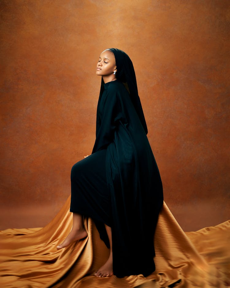 Woman Wearing Black Veil Sitting On Chair 