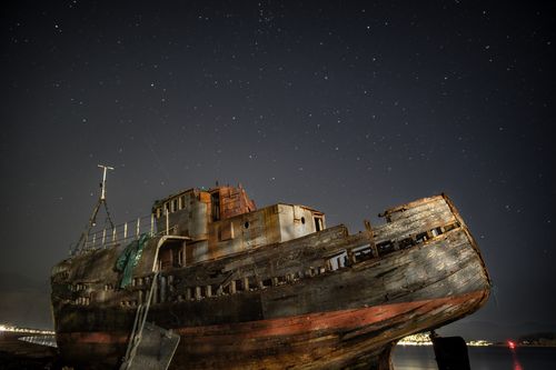 Free Captivating image of a rusty shipwreck under a starry night sky, located on the Scottish coast. Stock Photo