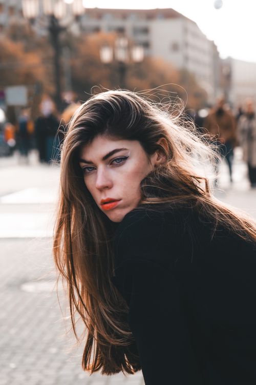 Free Captivating portrait of a woman in an urban city street setting exuding confidence and style. Stock Photo