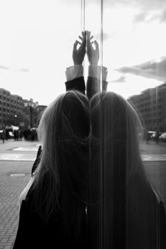 Artistic silhouette against Berlin's modern urban architecture with dramatic reflections.