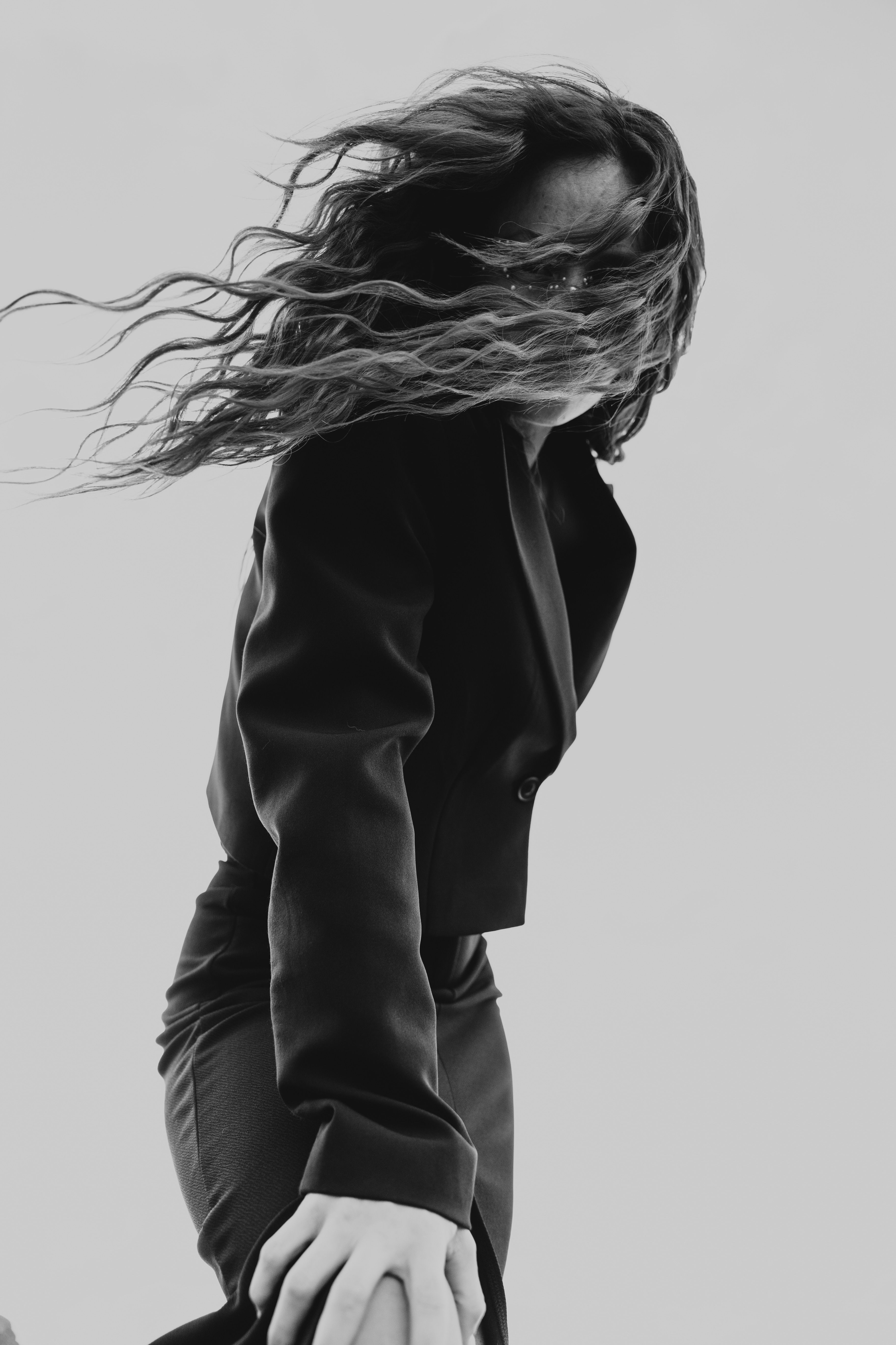 A woman with her hair blowing in the wind · Free Stock Photo
