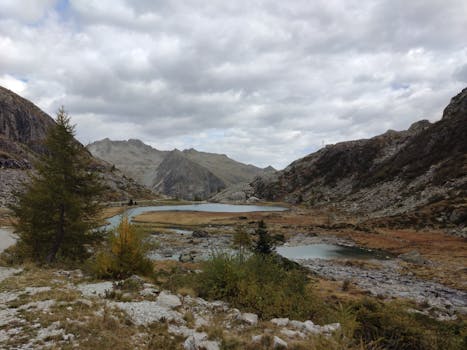 Majestic alpine view in Pinzolo, Italy, featuring serene lakes and rugged hills.