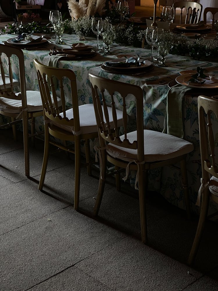 Empty Chairs By Decorated Restaurant Table