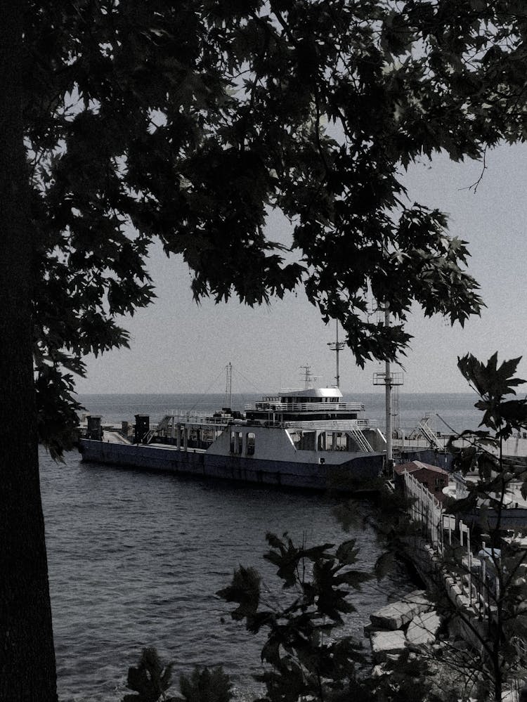 A Commercial Boat In The Port Seen From The Land 