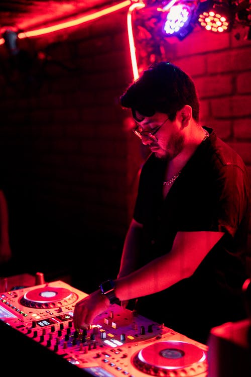 DJ by Mixer in Nightclub