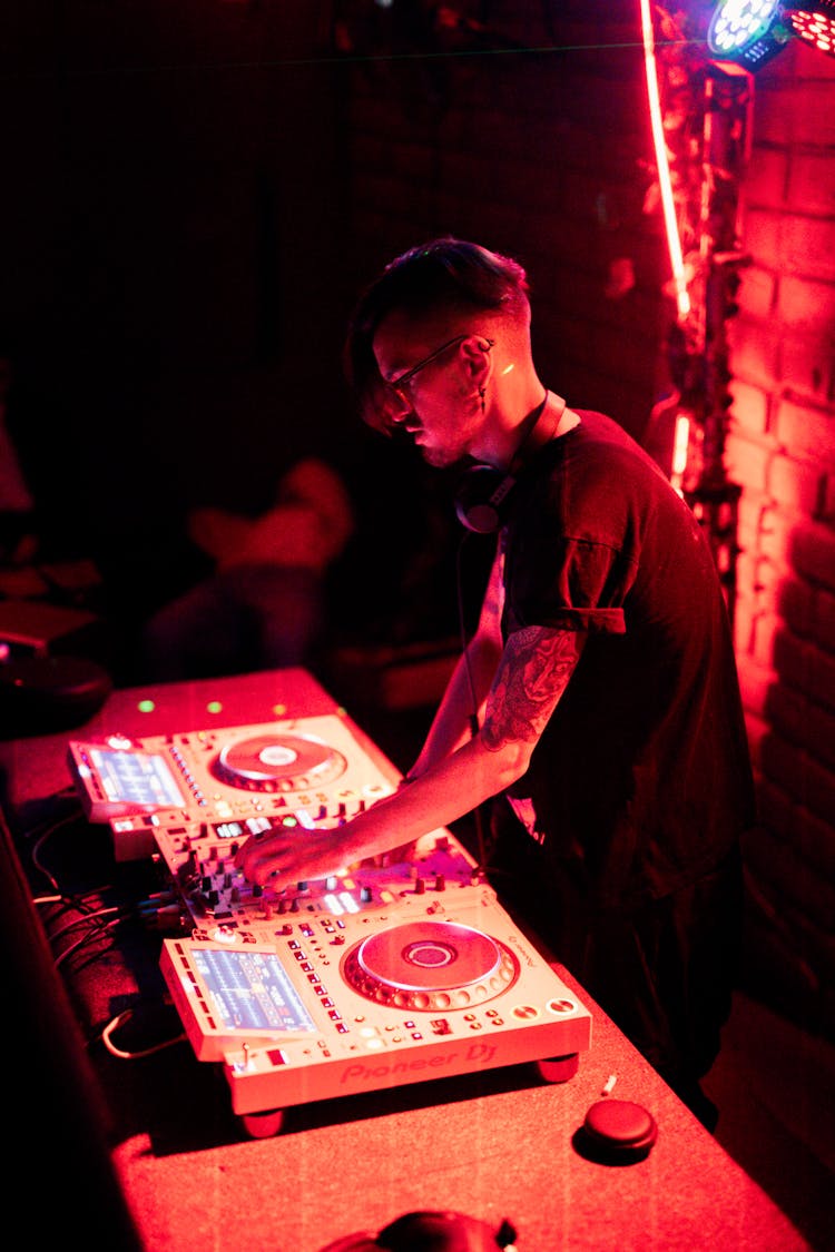 Young Brunette Working With Mixer In Nightclub