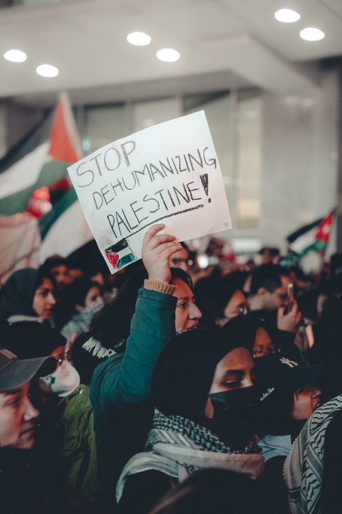 Free A diverse crowd holds signs advocating Palestinian rights during a peaceful protest. Stock Photo