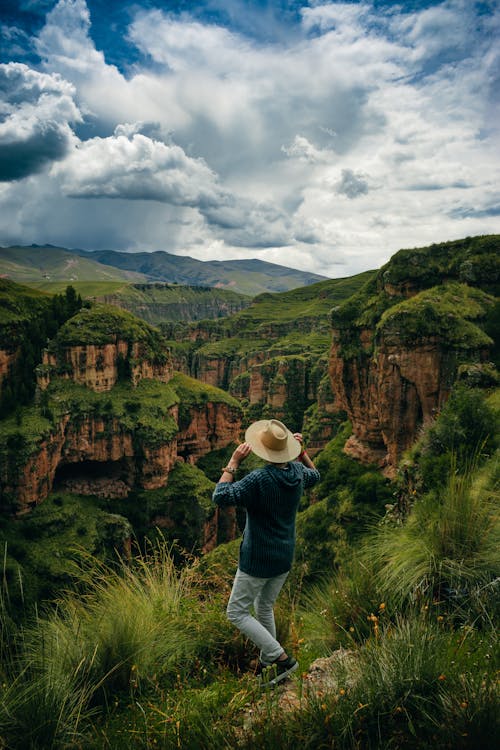 Person with Hat Standing by Canyon in Peru