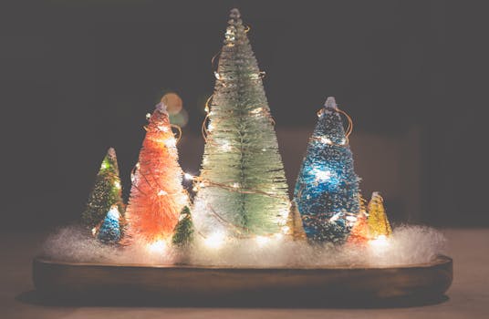 Colorful illuminated Christmas tree decorations on a snowy base.