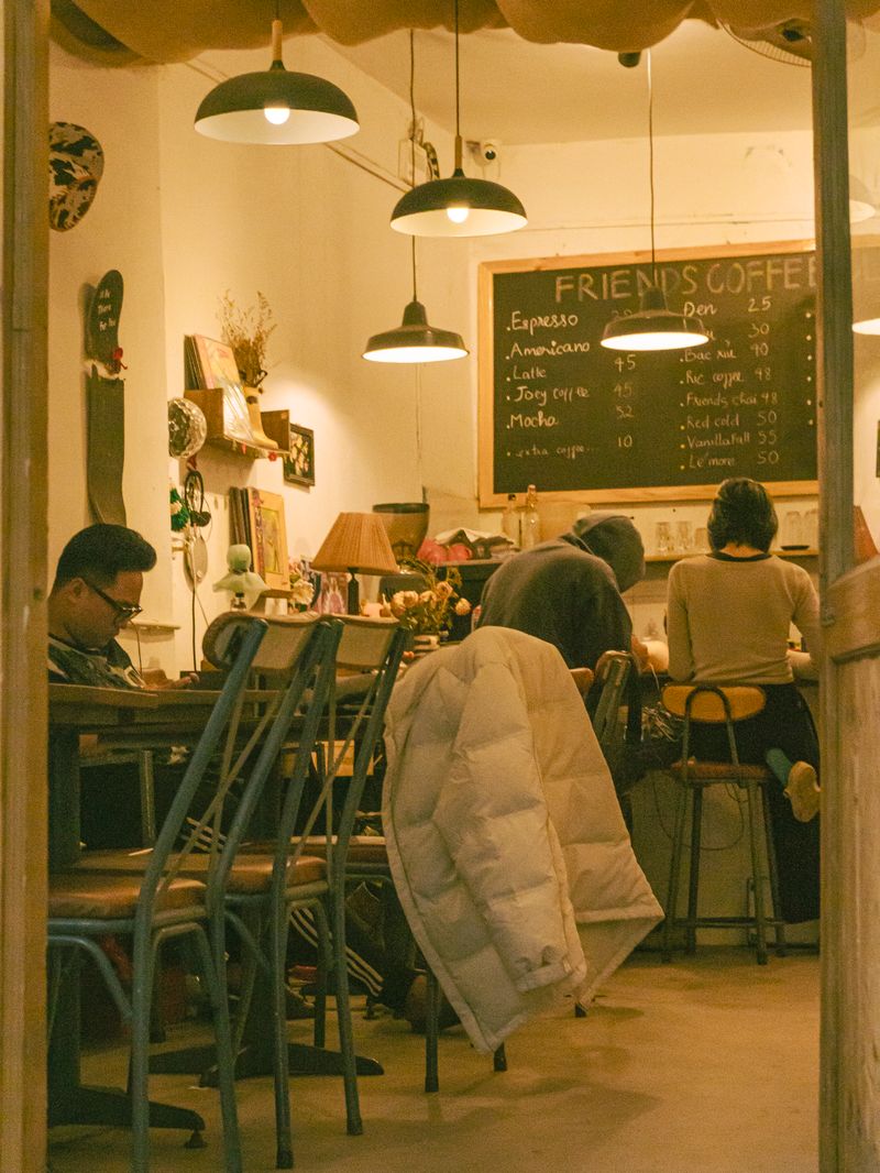 Two friends chatting over coffee in a warm cafe