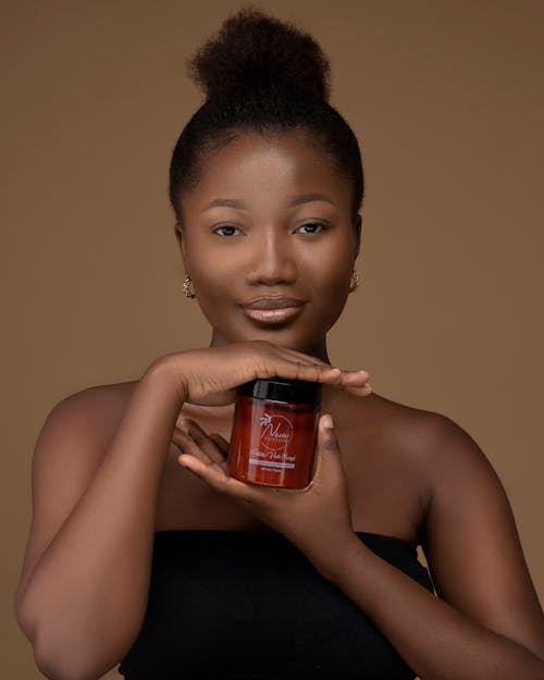 Portrait of an African Woman Holding Cosmetics 