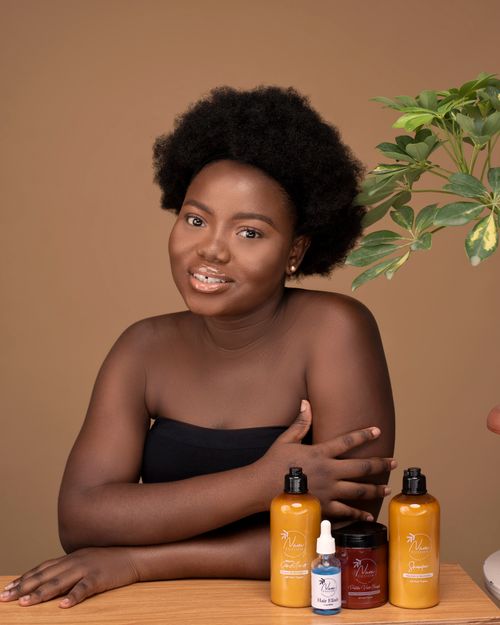Free Portrait of a woman with skincare products, studio setting. Stock Photo