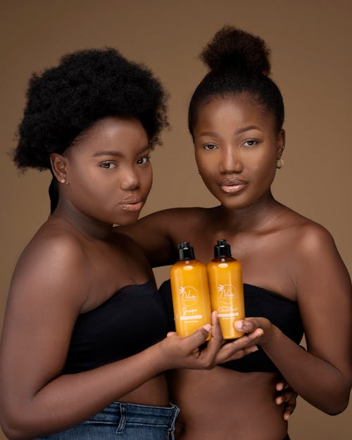 Models Showing Bottles of Beauty Products