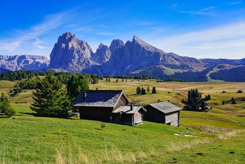 Scenic View of a Village and the Sassolungo Mountain in the Dolomites