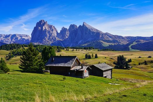 A cabin in the mountains with a mountain range in the background