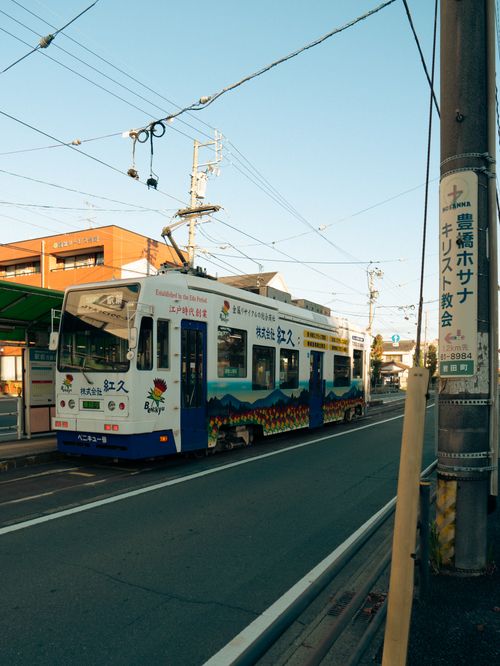 Free Vibrant tram on a city street in Toyohashi, Aichi, Japan, on a sunny day. Stock Photo
