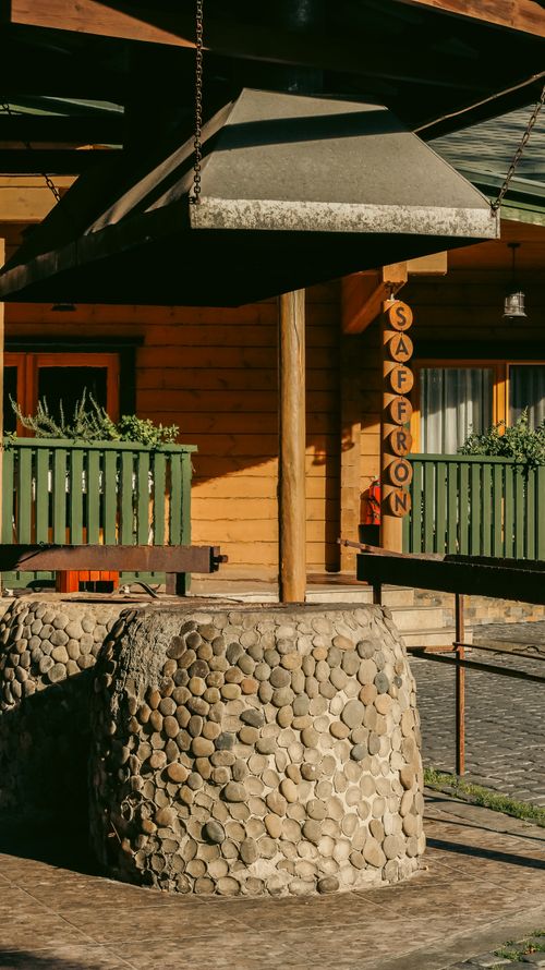 Free Outdoor stone barbecue with rustic extractor hood at a restaurant named Saffron. Stock Photo