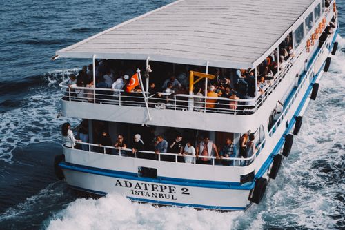 Free Passengers enjoy a scenic ferry ride on the Bosphorus in Istanbul, Turkey. Stock Photo