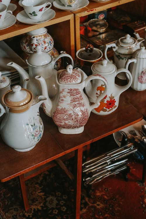 Free Collection of Decorated Porcelain Teapots on the Table Stock Photo