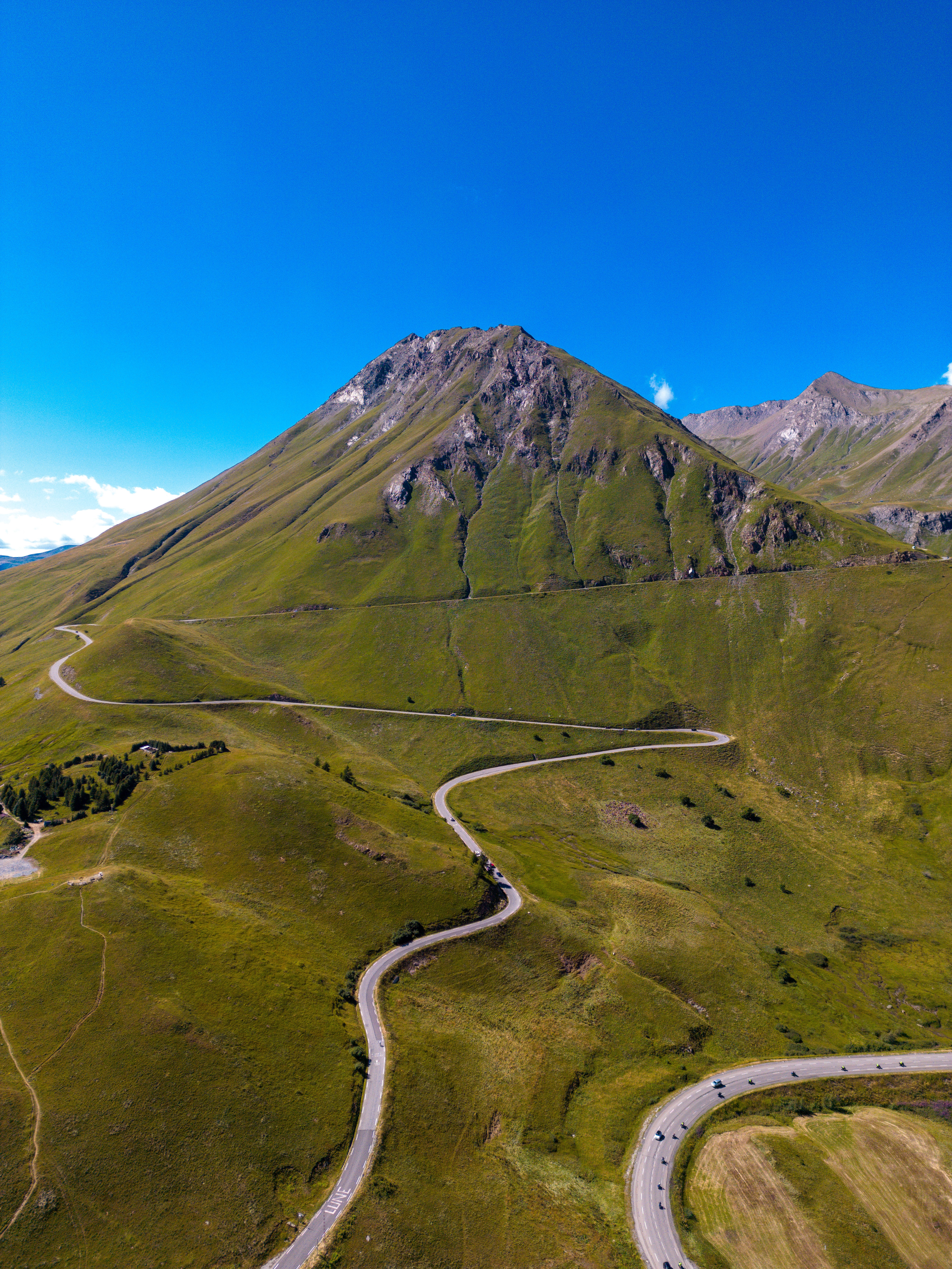 Aerial View of a Green Mountain with a Winding Road Leading to the Top ...
