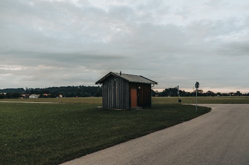 A Wooden Shed on the Grass Field in the Countryside 