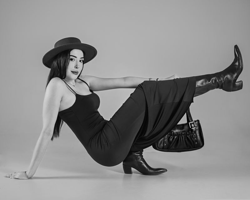 Woman in black dress and leather boots