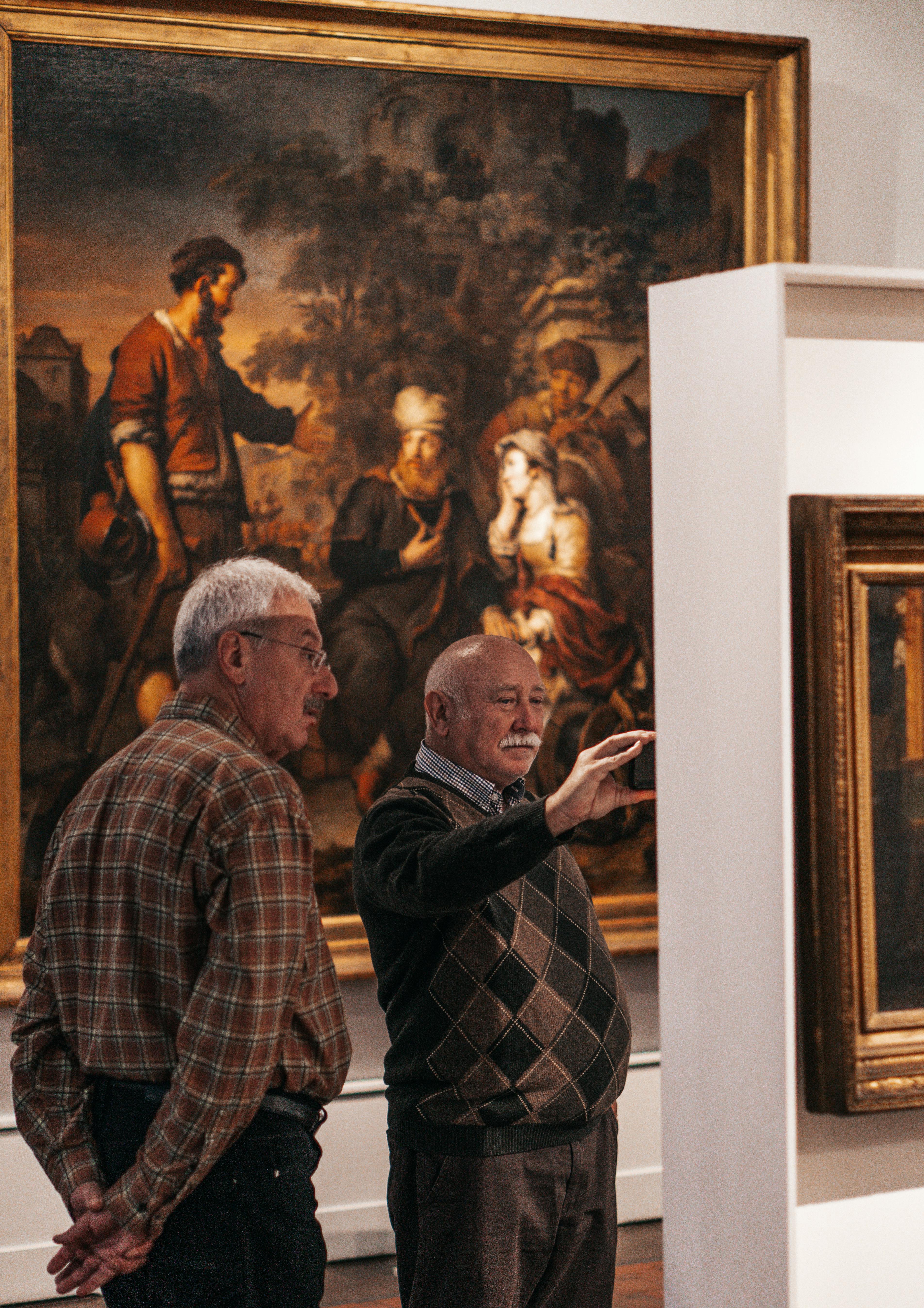 men looking at exhibition in a museum