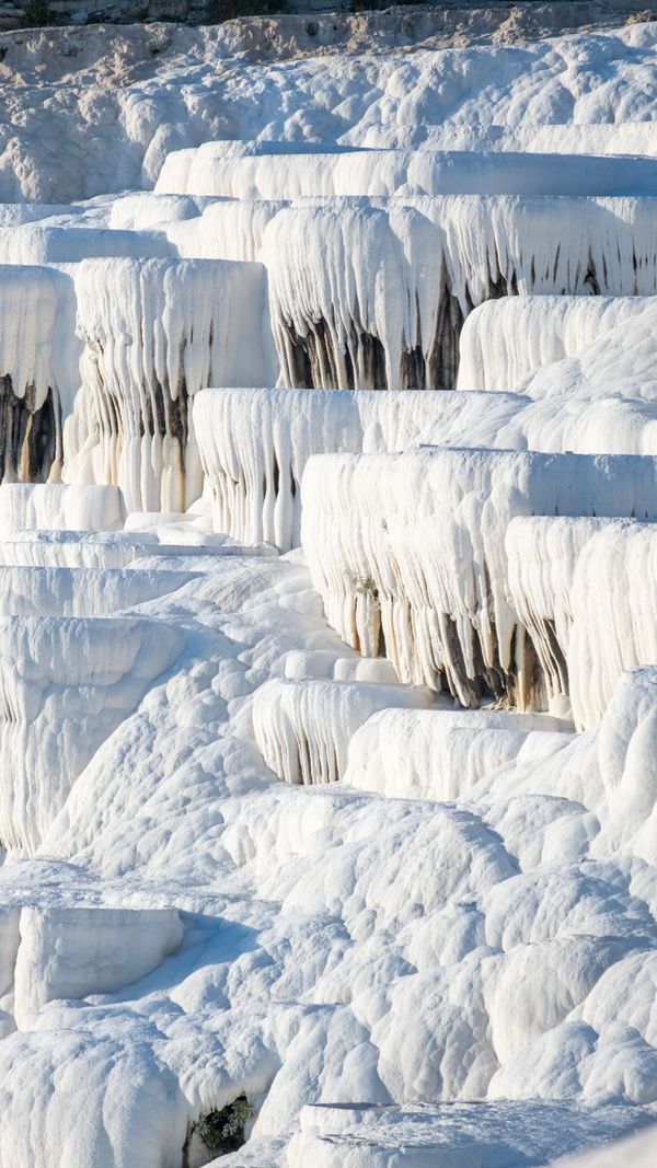 White calcium travertine terraces of Pamukkale thermal pools Turkey